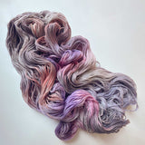 Lilac merino yarn in variegated lavender, pink, purple, peach, and blue