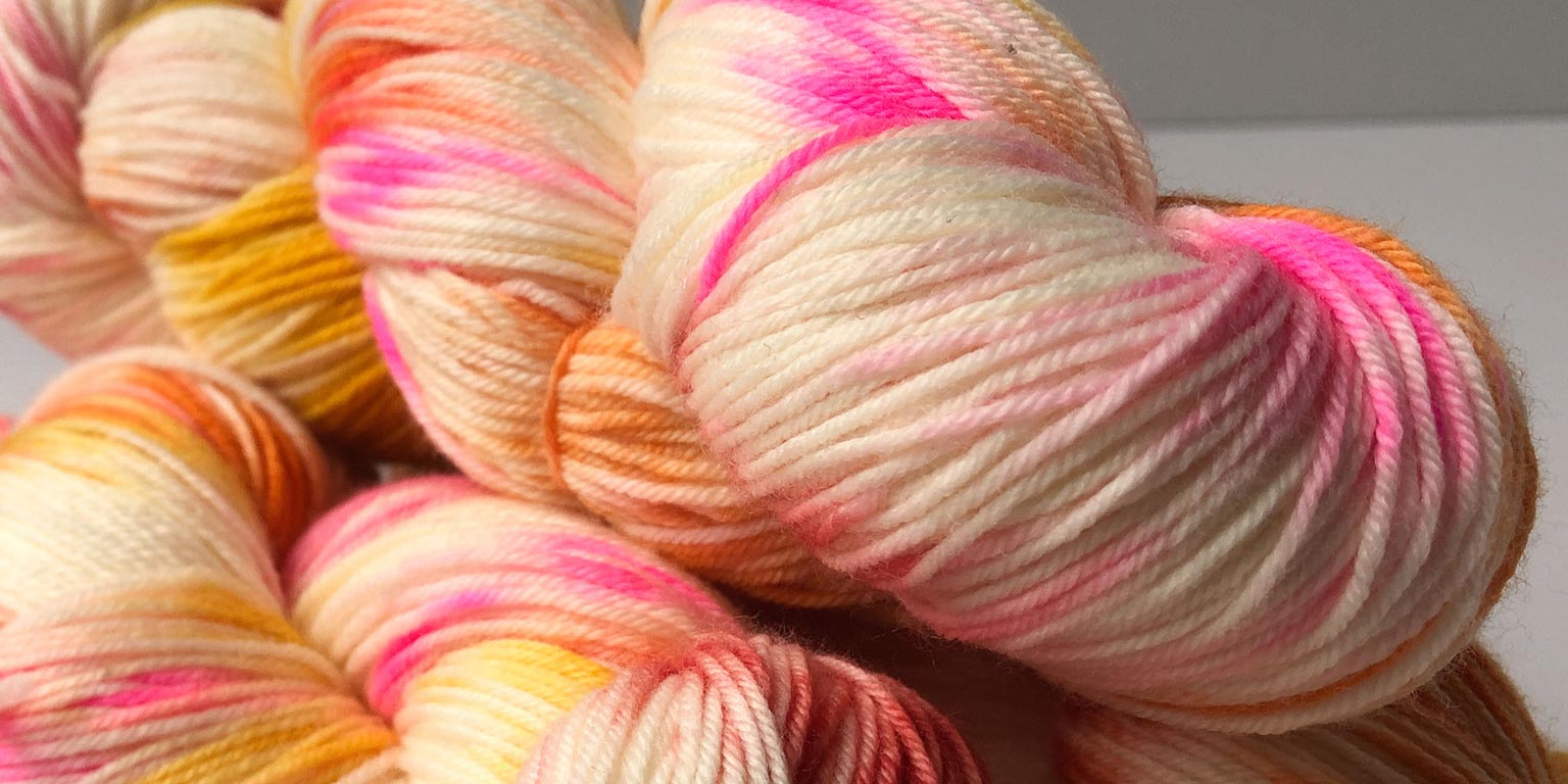 confetti cake yarn hand dyed by global backyard industries (pink, mustard, yellow, orange, coral)