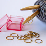 set of gold ring stitch markers comes with 15 in a pink storage case