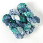 variegated artisan sock yarn in teal green and blue