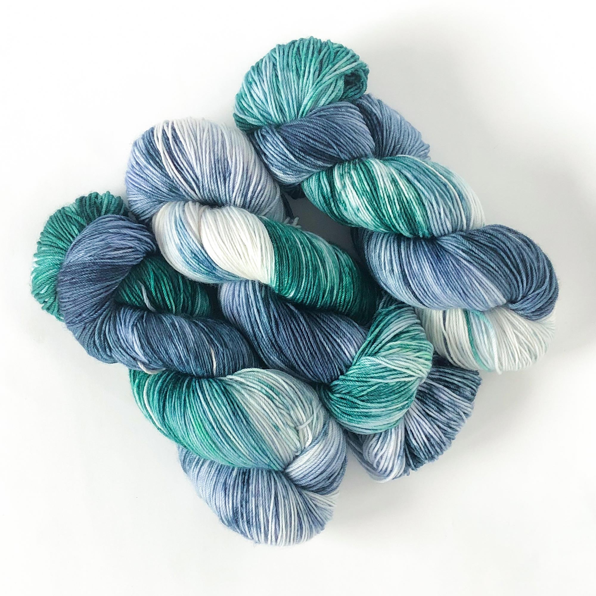 variegated artisan sock yarn in teal green and blue