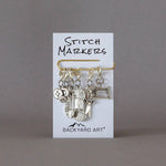 removable silver stitch marker set with a craft theme