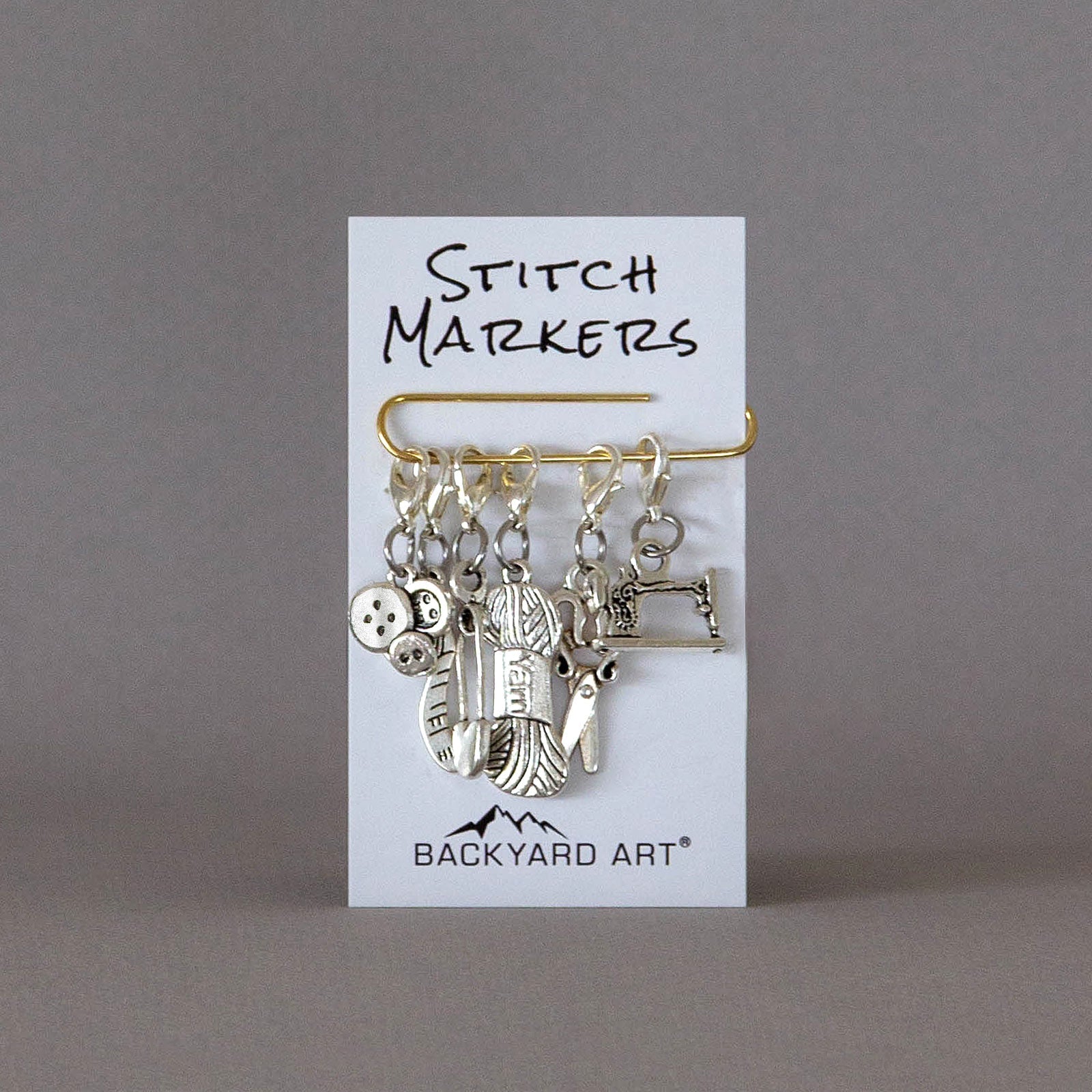 removable silver stitch marker set with a craft theme