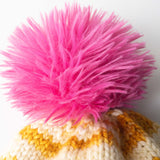 pink faux fur pom on knitted hat