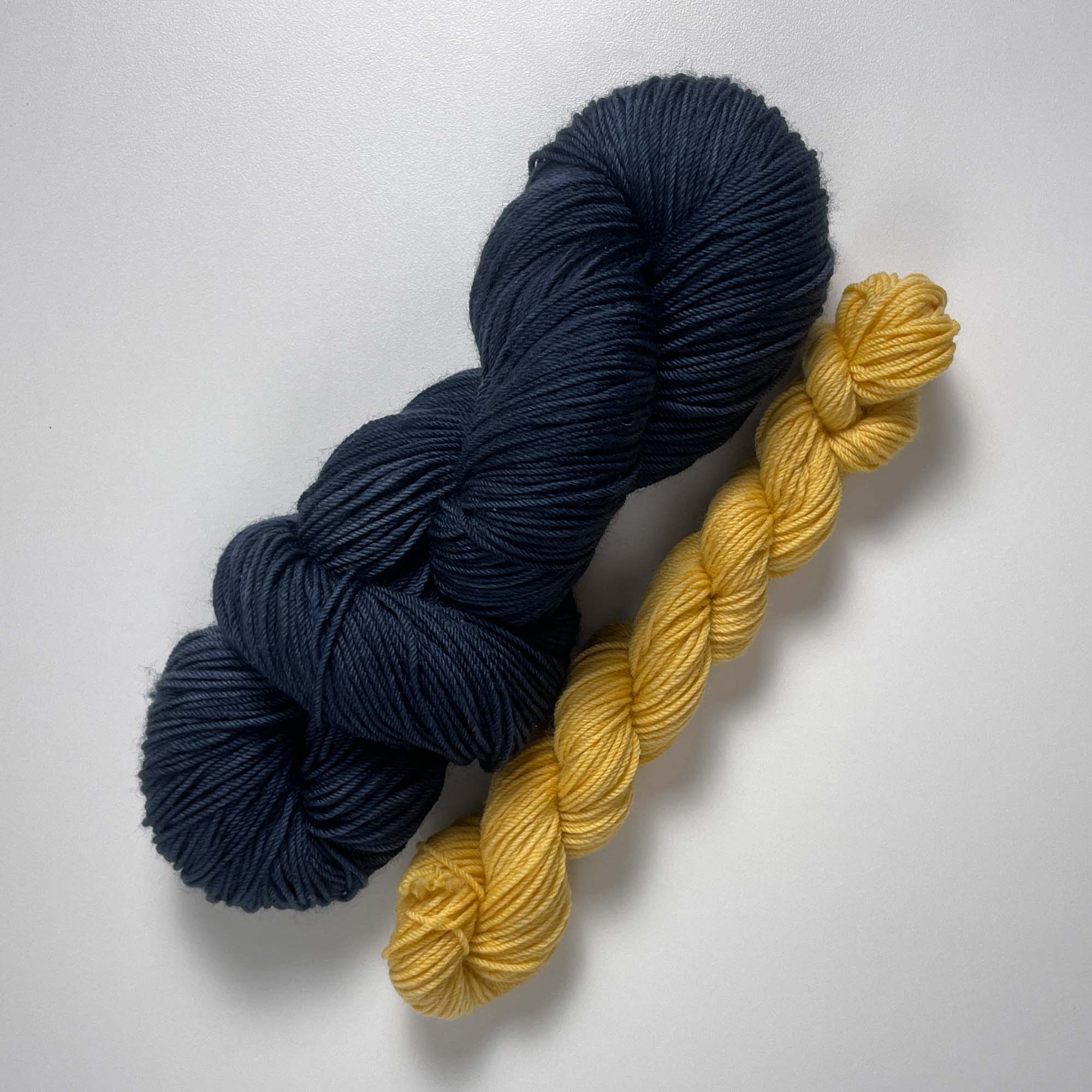 Quarter to Midnight deep blue gray yarn plus a calming yellow honeycomb mini 