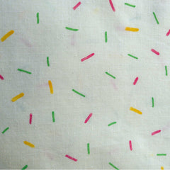 close up of colorful confetti pattern painted with green, yellow, and pink