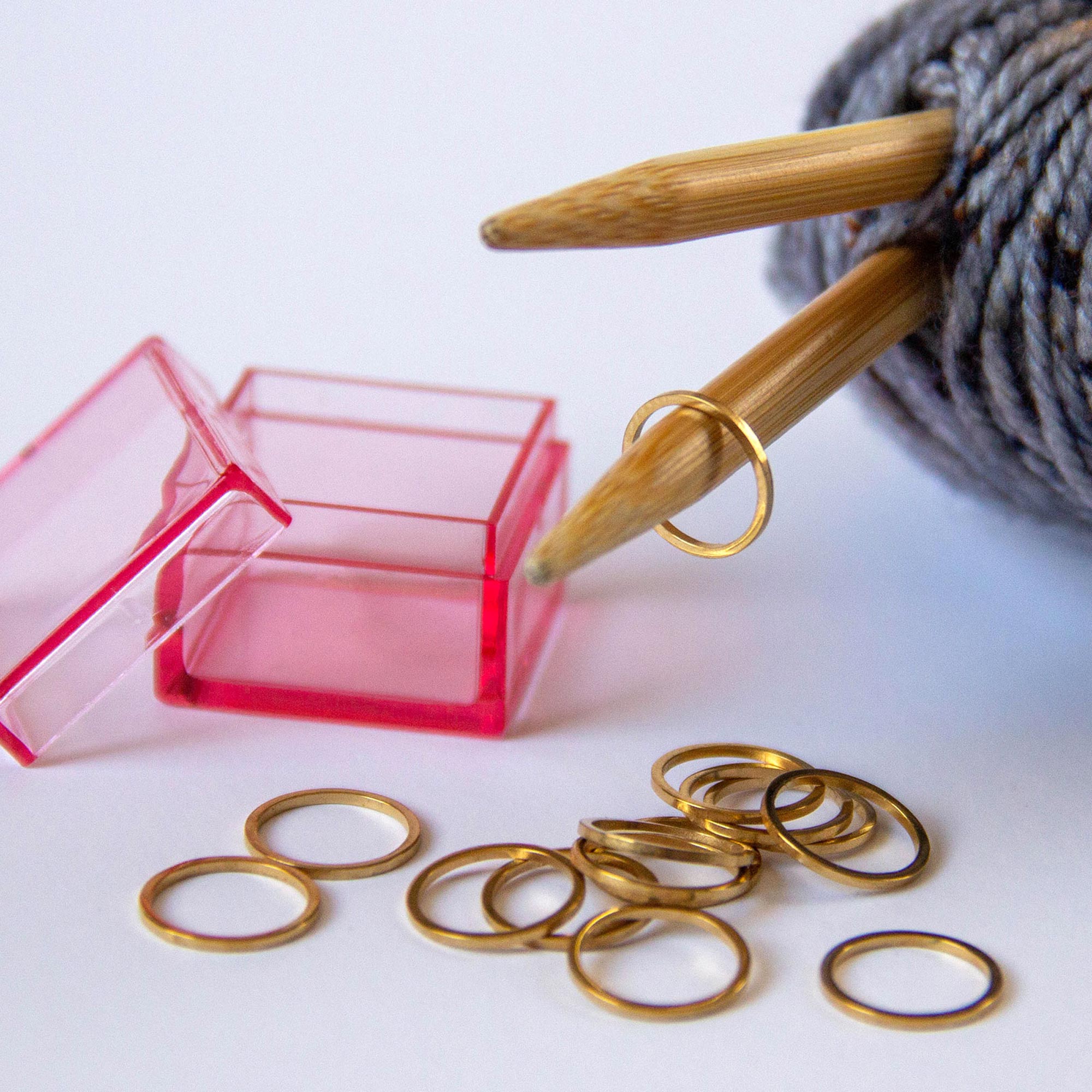 set of gold ring stitch markers comes with 15 in a pink storage case
