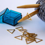 Triangle Stitch Markers - Metallic Gold Stainless in blue storage case