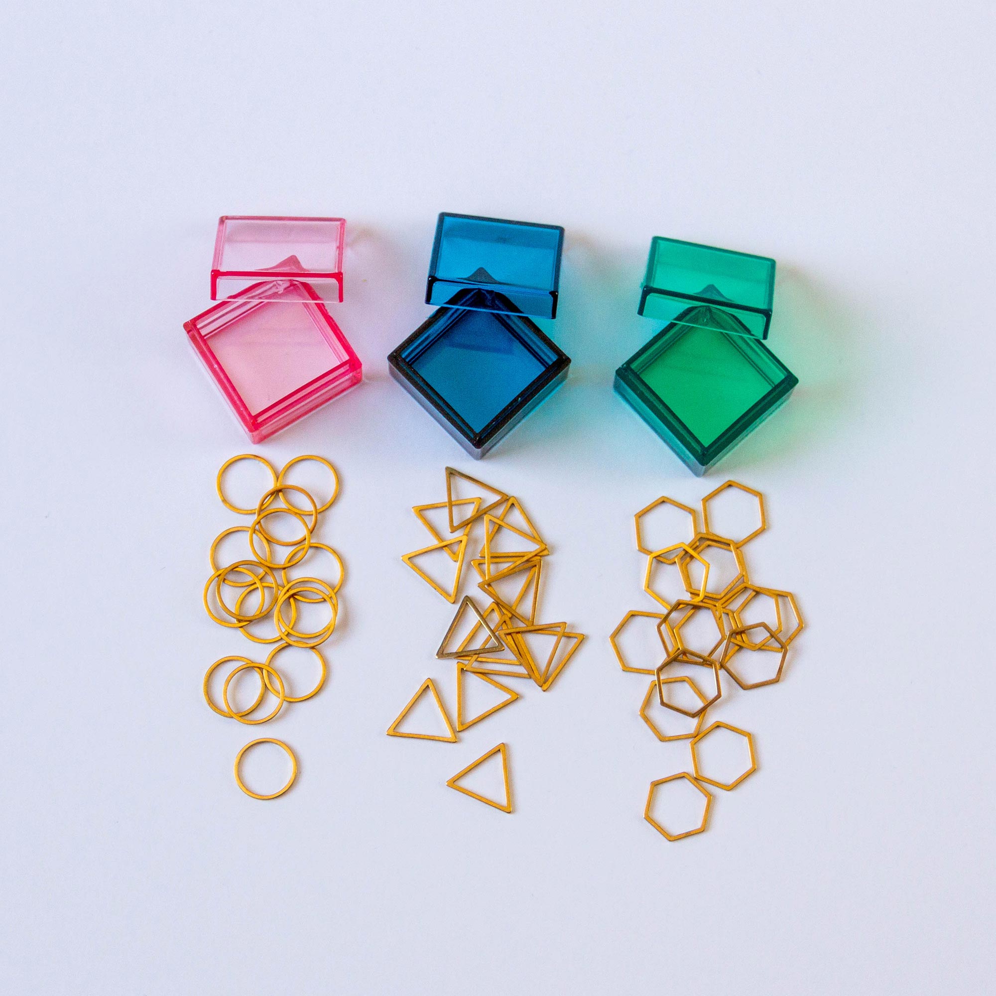 several sets of our shaped metal stitch markers