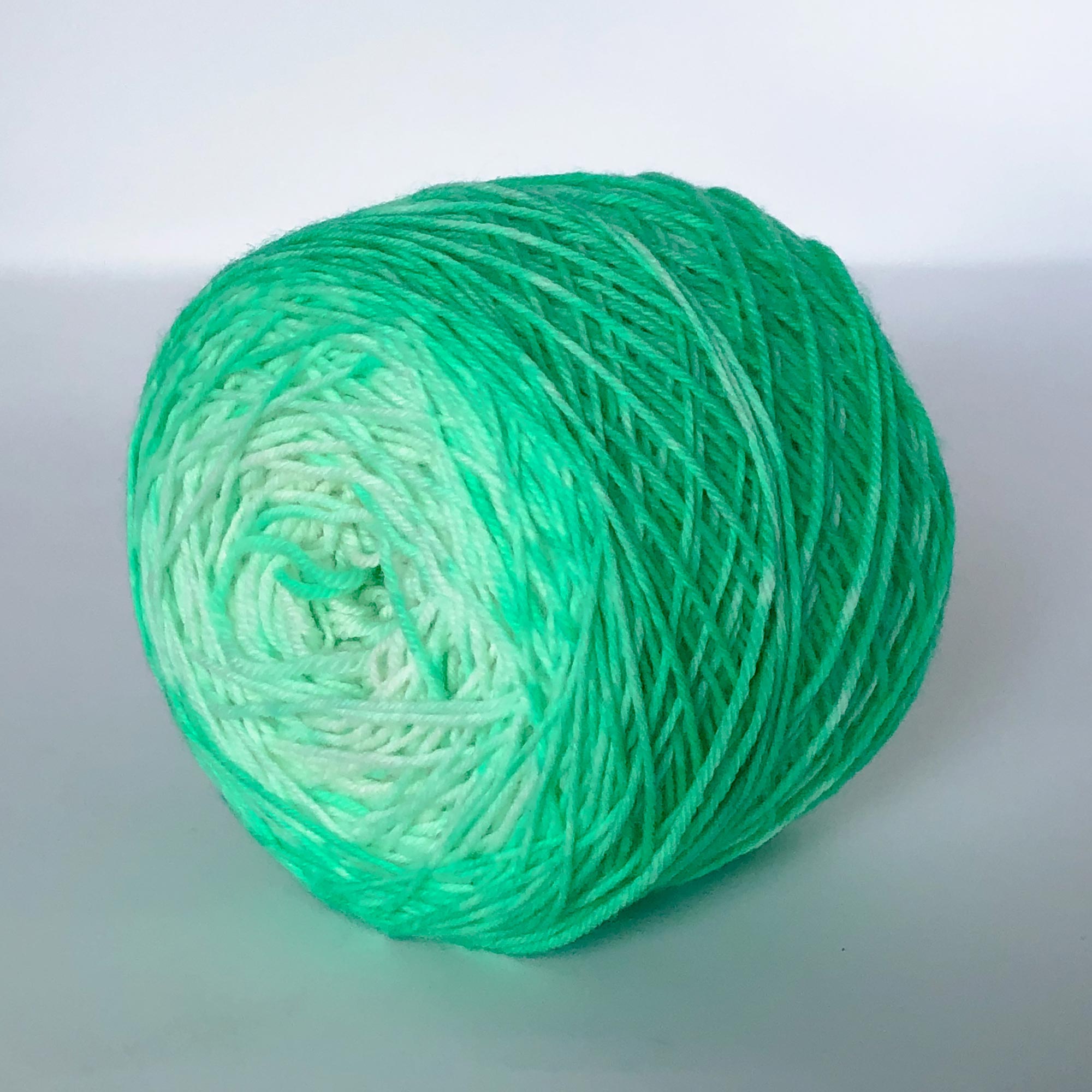 a caked example of our lime and coconut gradient sock wool