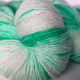 close-up on our green and white hand dyed fingering weight yarn 