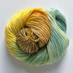hand-dyed yarn in tones of brown, orange, gold, yellow, sage green and blue spruce