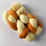 Dreamsicle sock yarn in extrafine merino -- variegated assigned pooling orange and cream and lightly speckled