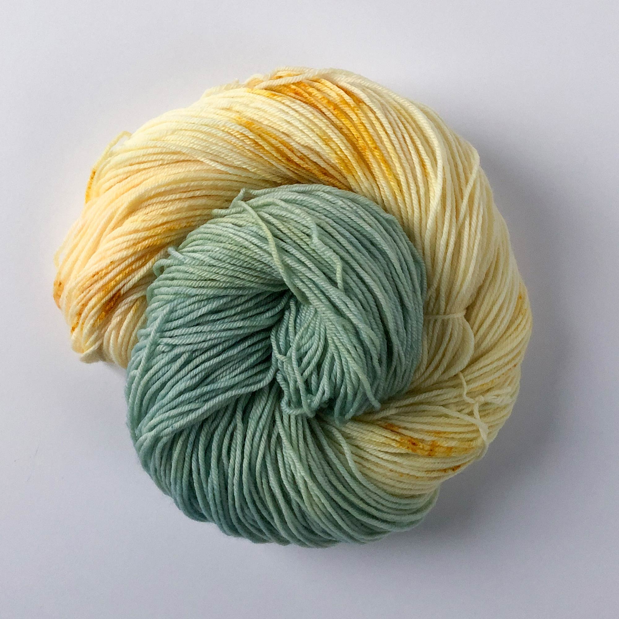 assigned pooling blue, yellow, and cream fingering-weight hand-dyed yarn 
