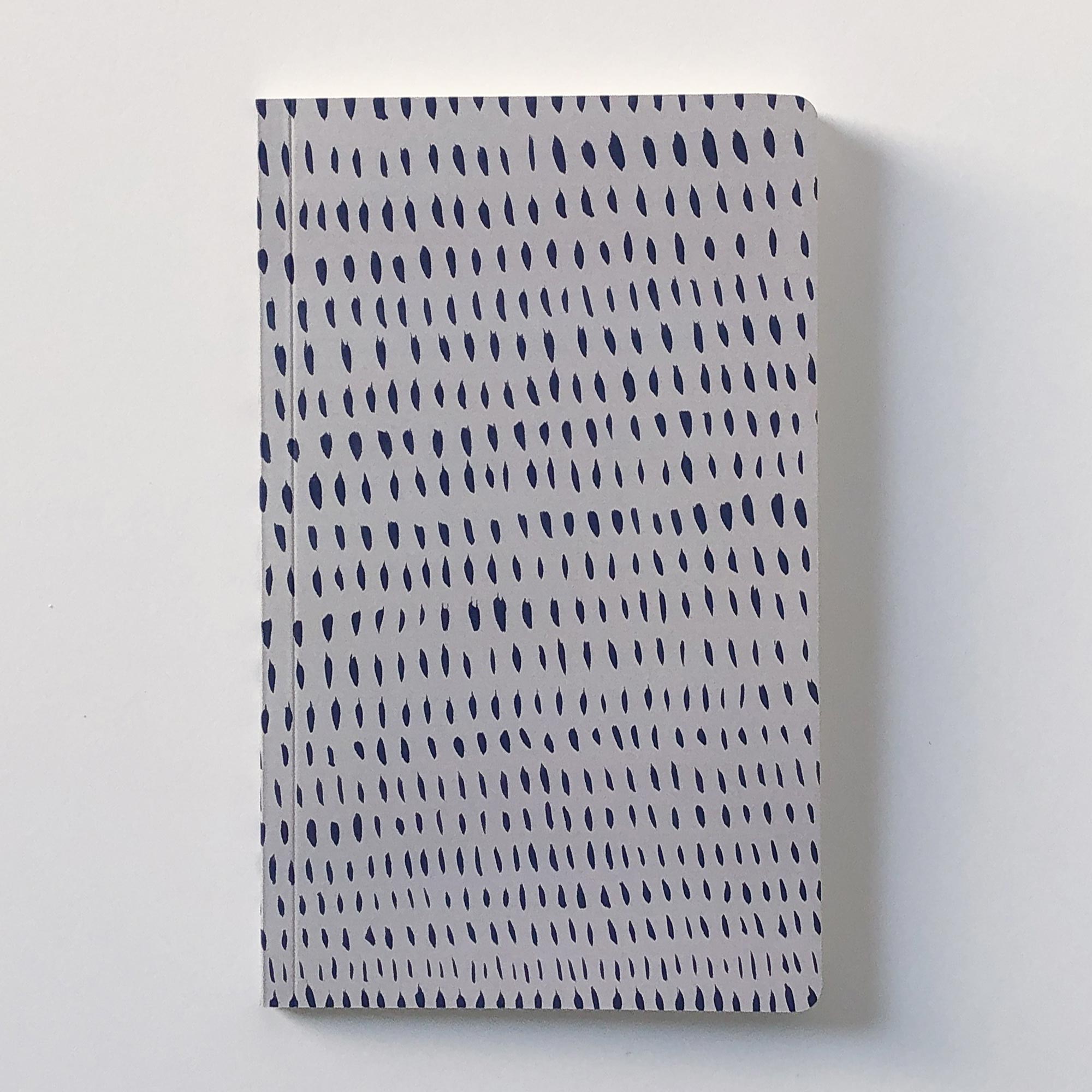 blue and gray notebook with organic illustration on front and  back covers