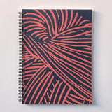 our abstracted yarn illustration decorates the front and back of this spiral, perforated page notebook 