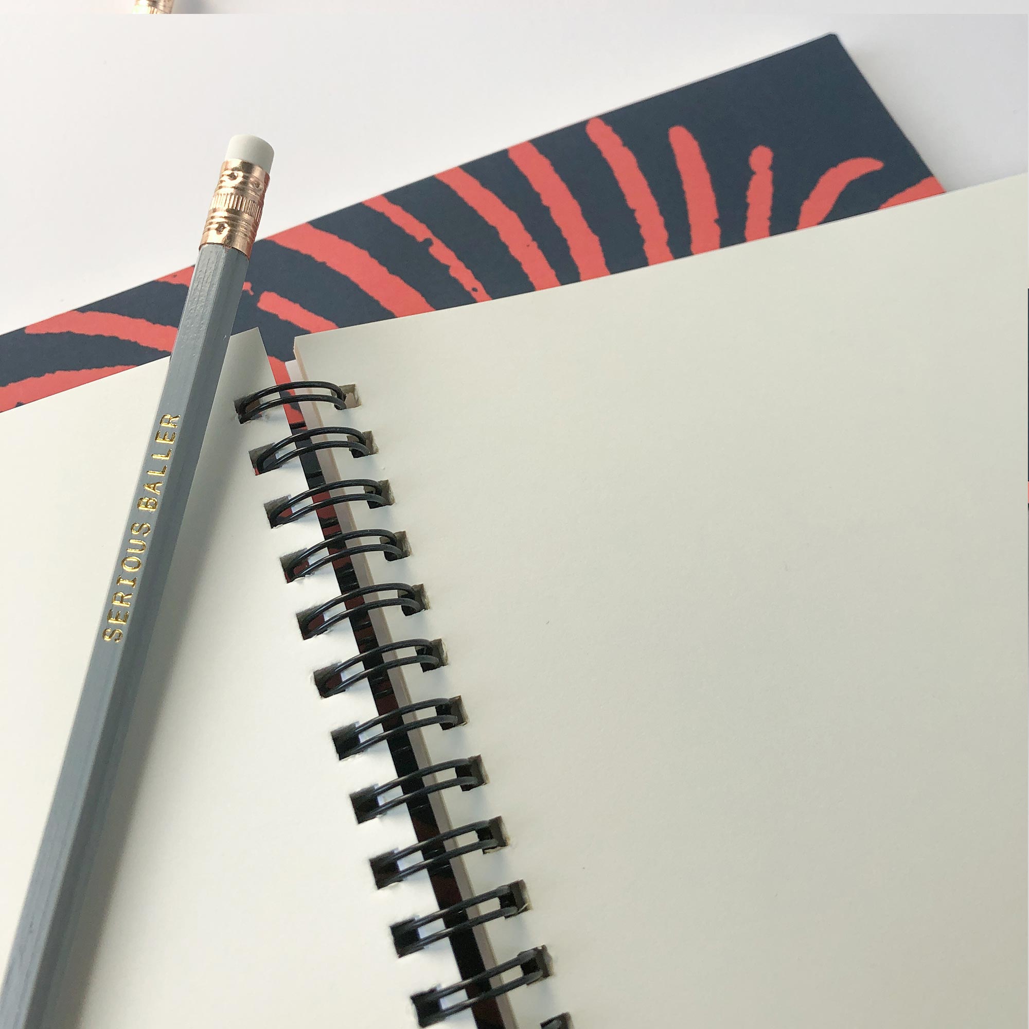 plain paper notebook with perforated pages and lay-flat spiral binding