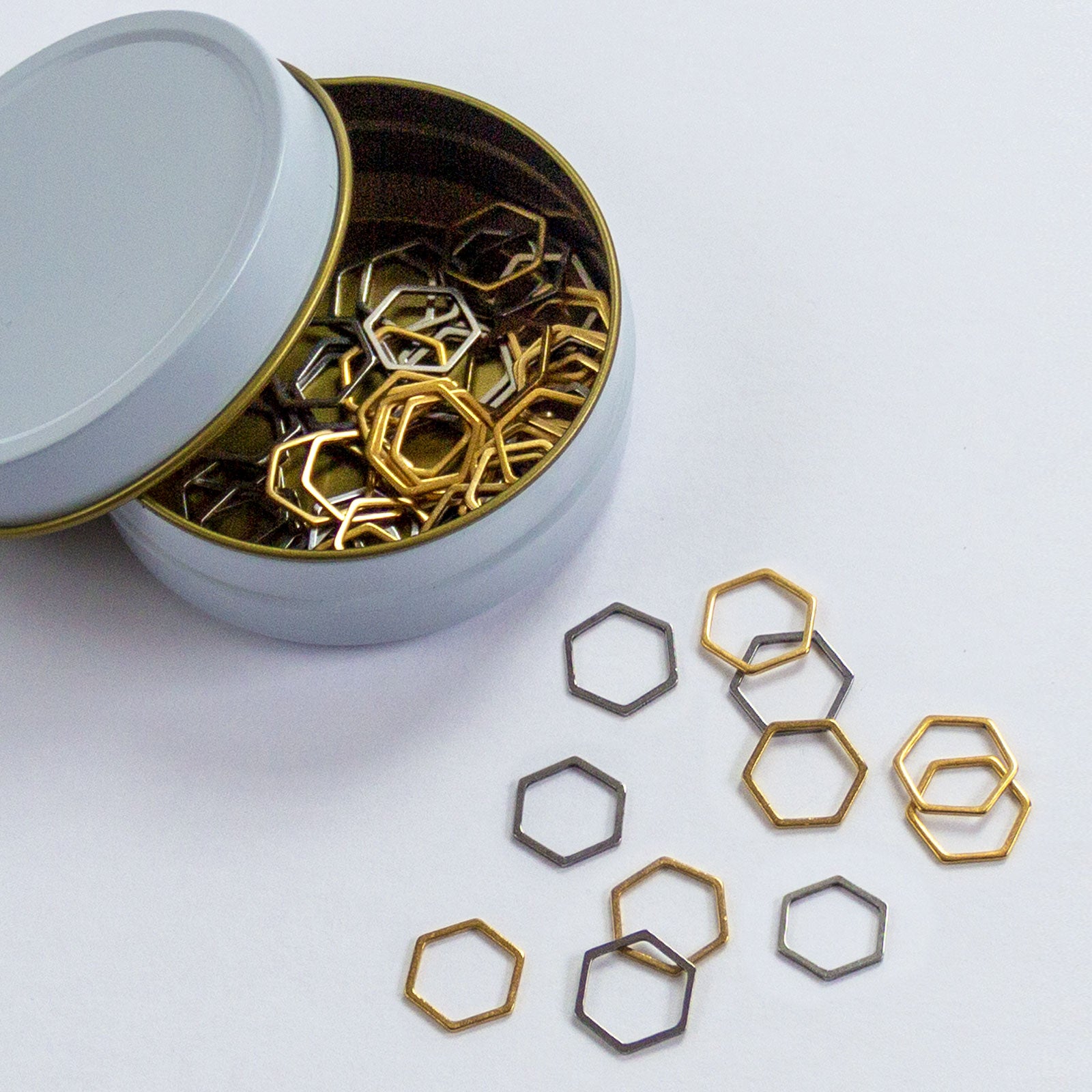 metal hexagon stitch markers in white and gold storage tin