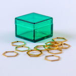 set of 15 metallic gold hexagon-shaped stitch markers in a pretty green translucent storage box