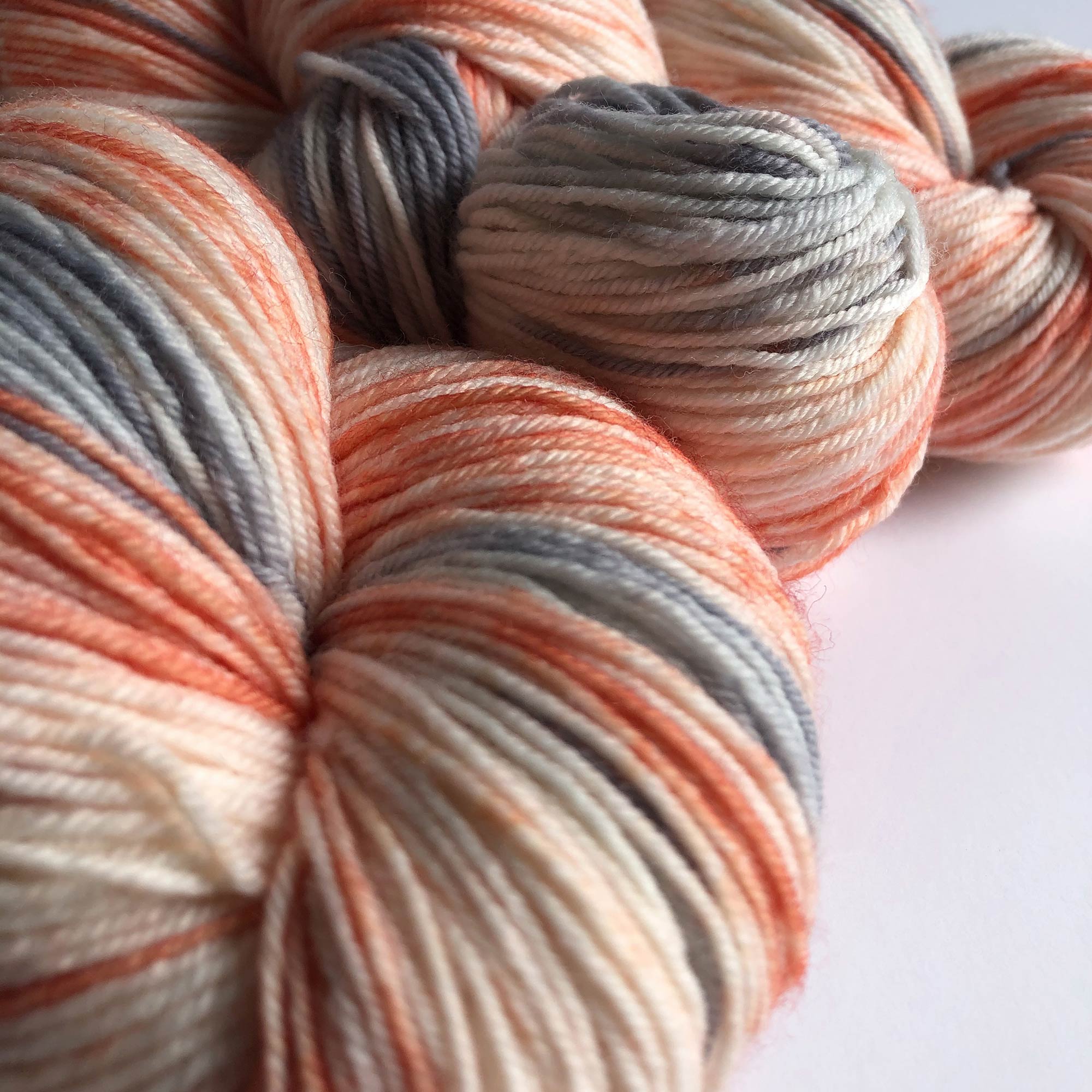 coral and silver gray space dyed sock yarn close up