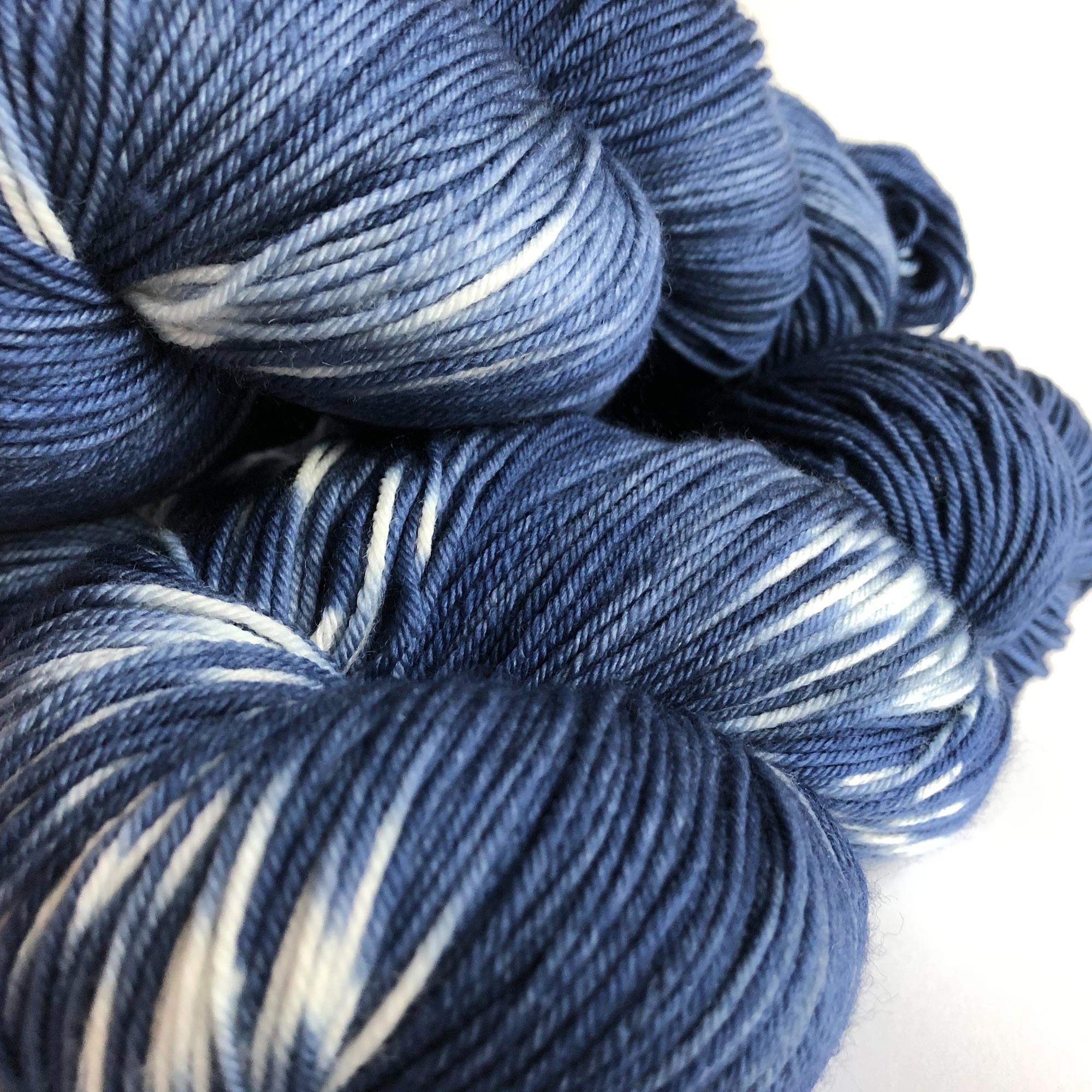close up of hand dyed indigo blue fingering weight yarn