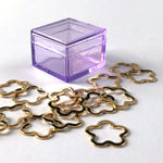 metal stitch markers in a flower shape with a lavender storage case