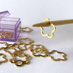 flower shaped gold-plated stainless steel stitch markers in a see-through acrylic lavender storage case 